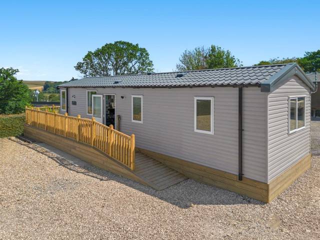 Exterior of Paws & Palms Retreat with decking and access ramp