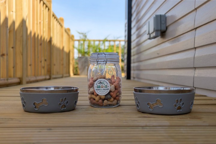 Dog bowls and a jar of dog treats on the terrace